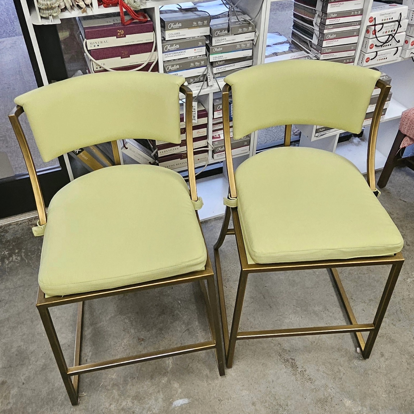 Counter stools in chartreuse with brass frames, reupholstered